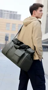 Men's olive green travel bag showing side pocket details and adjustable shoulder strap