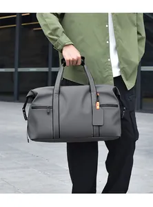 Close-up of large capacity travel duffel bag showing zipper pockets and orange detail