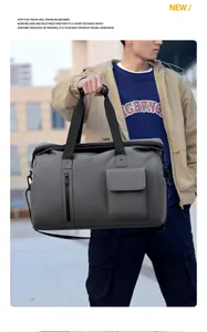 Close-up of a charcoal grey travel bag featuring front zip pocket and textured waterproof fabric
