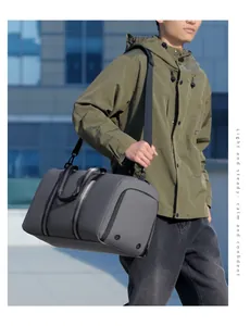 Waterproof grey travel bag with black nylon handles and adjustable shoulder strap
