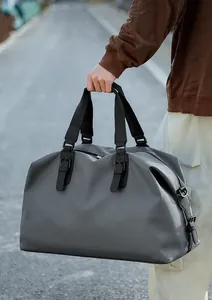 Close-up of the comfortable reinforced handles and metal hooks on this dark grey travel bag