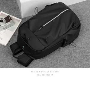 Detail of waterproof black backpack with reflective zipper and cable port on grey background