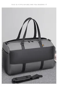 Detailed view of the large capacity duffel bag with grey-black color and durable handles