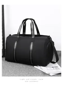 Black large capacity travel bag featuring waterproof fabric and side pocket detail
