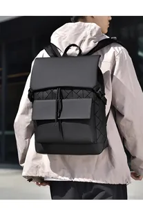 Macro detail of the matte geometric block stitching and texture on this black backpack