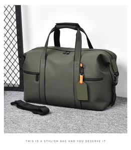 Close-up of olive green travel bag showing waterproof matte fabric and orange label detail