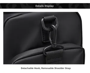 Detail view of the detachable metal hook and woven shoulder strap on black travel bag