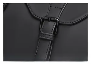 Detail shot of durable black metal buckle and reinforced stitching on travel bag