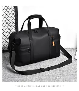 Detail view of large travel bag with reinforced handles and orange accent tag