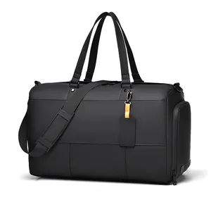 Detail view of large black waterproof fitness bag with top handles and shoulder strap