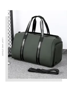 Olive green travel duffel with black striped handles and Light and Steady text details