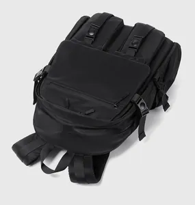 Close-up of black multi-pocket backpack showing breathable mesh back and wide straps