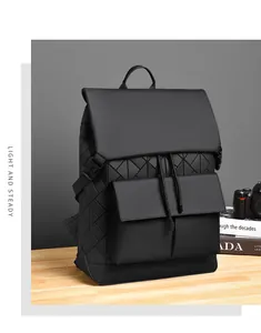 Detail view of black geometric quilted backpack with buckle closure and drawstring