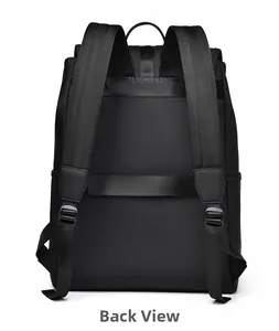 Detail view of the black backpack back with luggage strap and padded shoulder straps