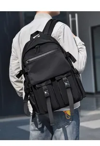 Close-up of black tactical backpack showing buckle straps and water-resistant nylon texture
