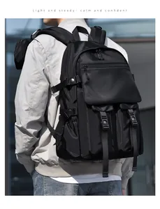 Outdoor shot of a black tactical style backpack with functional buckles and straps