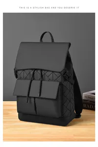 Detailed view of the matte geometric triangular pattern and front flap pocket on a black backpack