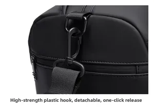 Detail of high-strength detachable plastic hook and nylon strap on black travel bag