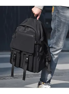 Detail of black nylon backpack featuring breathable mesh back padding and buckle straps