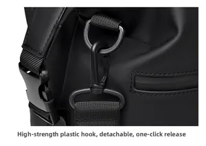 Detail of high-strength plastic swivel hook and D-ring buckle on black travel bag