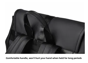 Detail of comfortable padded handle on black matte waterproof travel backpack