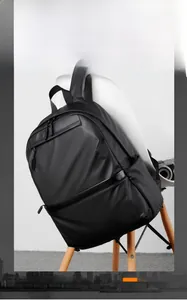 Detailed view of the sleek black water-resistant fabric and premium metal zippers on the backpack