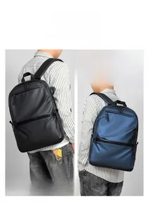 Detail view of stylish matte waterproof backpacks in black and blue on a male model