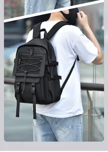 Detail of black tactical backpack with adjustable buckles and elastic bungee cord system