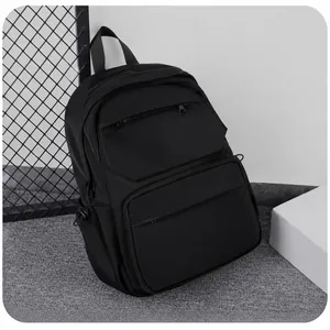 Detail of waterproof black backpack showing large capacity interior and reflective safety strip
