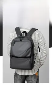 Detail of dark grey business backpack showing water-resistant fabric and zippers