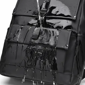 Waterproof black commuter backpack with flap closure showing water droplets on matte surface