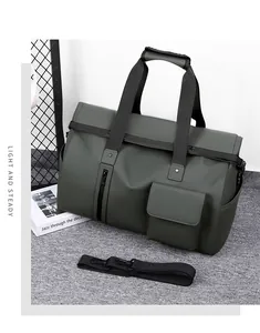 Detail view of olive green waterproof travel bag with double handles and shoulder strap
