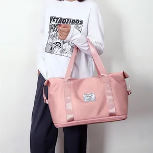 Bolso de viaje rosa de nailon impermeable de gran capacidad con asas anchas