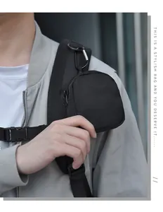 Close-up of a black modular mini pouch with a zipper on a backpack shoulder strap