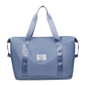 Bolsa de viaje azul plegable de gran capacidad con tela impermeable y zapatero