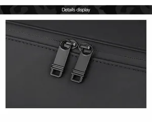 Detail showing smooth dual metal zippers on water-resistant black travel bag material