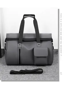 Deep gray travel bag showing waterproof texture, front zipper pocket and adjustable strap