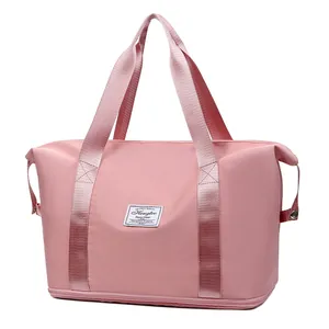 Borsa da viaggio rosa grande capacità in nylon impermeabile con manici e toppa logo