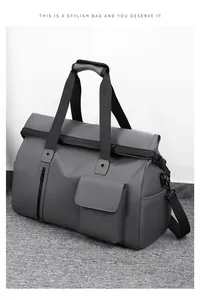 Detail of grey travel bag with multi-pocket design and adjustable shoulder strap