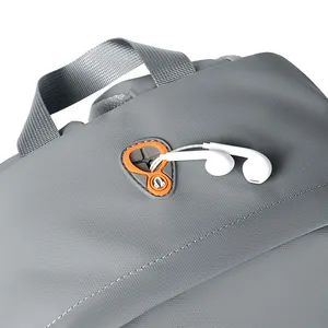 Grey nylon laptop backpack with top handle and functional orange silicone earphone port