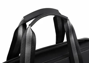 Ergonomic rubber handle and striped nylon strap detail of a waterproof travel bag
