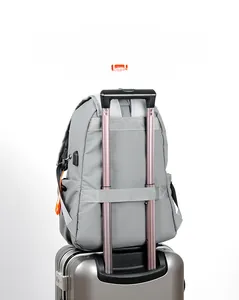 Detail of grey travel backpack with luggage strap and integrated USB charging port
