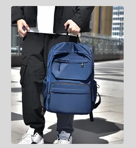 Detail view of water-resistant navy blue nylon outdoor backpack with multi-layer zipper pockets