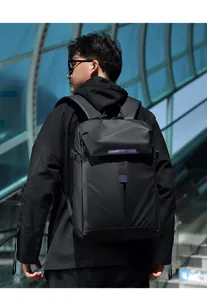 Ergonomic black waterproof backpack shown on person in a professional outdoor setting