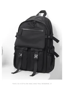 Detail of black tactical backpack showing multiple pockets and adjustable buckles