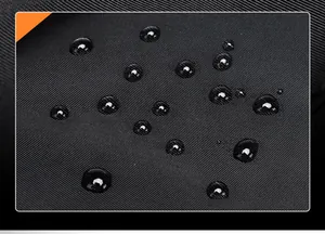 Macro shot of waterproof black high-density fabric with water droplets on computer bag