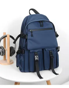 Macro detail of navy blue waterproof backpack with zippers, buckle straps and side pockets