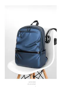 Detail view of water-resistant metallic blue business backpack on a white chair