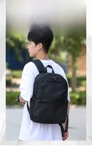 Outdoor lifestyle shot of a black minimalist multipurpose backpack for men