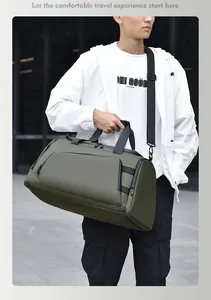 Detailed view of the olive green travel bag with handles and adjustable shoulder strap